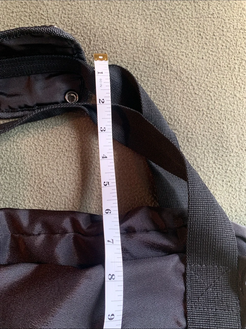 EUC black nylon duffel bag with strap. Approximately 22” x 14” x 10.5”